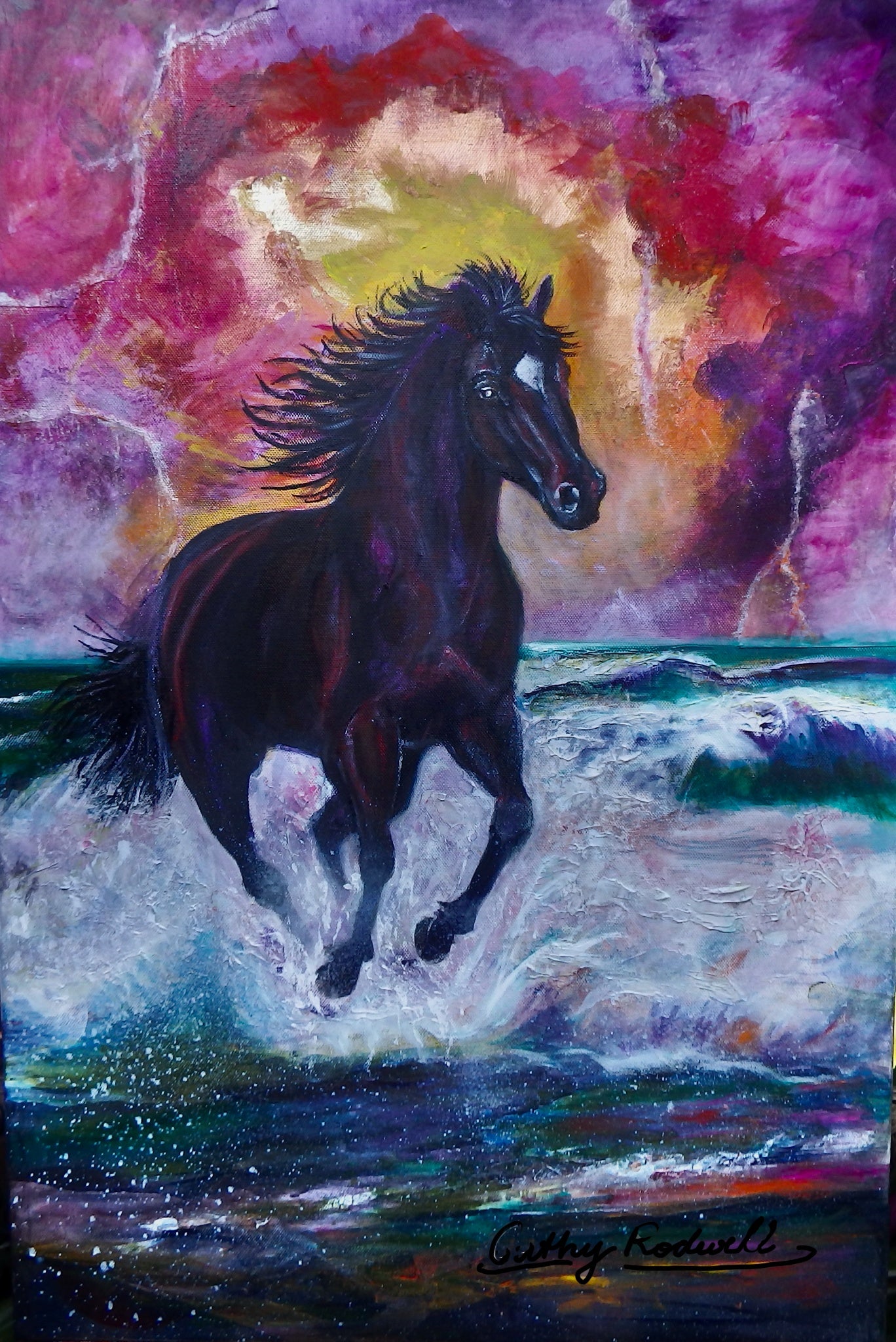 Fire Horse by Cathy Rodwell, an original painting of a black stallion galloping through turquoise waves beneath a glowing pink, gold, and purple sky.